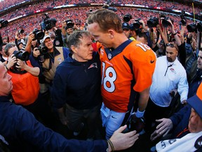 Head coach Bill Belichick of the New England Patriots congratulates Peyton Manning of the Denver Broncos after the Broncos defeated the New England Patriots during the AFC Championship game at Sports Authority Field at Mile High on January 19, 2014. (Kevin C. Cox/Getty Images/AFP)