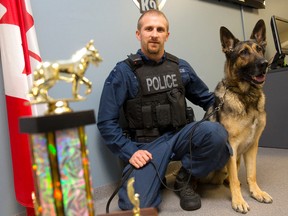 London Police Const. Andrew Stanley and police service dog Bosco pose for a photo with the trophy the pair won at a K9 tracking competition.  The partners are pictured here in their office at police headquarters in London on Wednesday October 29, 2014.
CRAIG GLOVER The London Free Press / QMI AGENCY