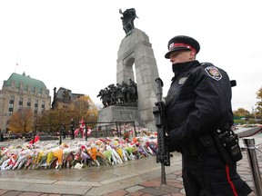 Ottawa police officers watched over the Royal Canadian Regiment at the National War Monument  in Ottawa Tuesday Oct 28,  2014.  Tony Caldwell/Ottawa Sun/QMI Agency