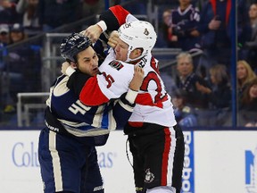 Senators' Chris Neil fights Blue Jackets' Jared Boll Tuesday night in Columbus. (Russell LaBounty-USA TODAY Sports)