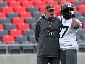 Ottawa RedBlacks RB Jeremiah Johnson chats with special teams coordinator and running backs coach Don Yanowsky during practice at TD Place Wednesday. Johnson will start Friday against Hamilton as the team continues to deal with injuries to several other running backs. (Chris Hofley/Ottawa Sun)