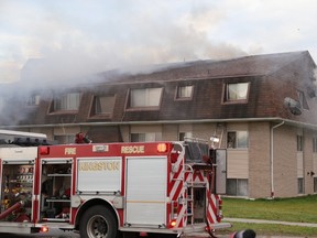 Kingston Fire & Rescue firefighters extinguish a blaze in a Conacher Drive apartment on Wednesday. (Ian MacAlpine/The Whig-Standard)