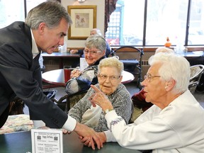 Alberta Premier Jim Prentice chats with residents of the Kiwanis Place Lodge, 10330 120 St., after announcing $70 million in upgrades to sprinkler and fire safety systems in senior care facilities on Wednesday. (David Bloom/Edmonton Sun)