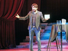 Jian Ghomeshi gestures on the Avon Theatre stage during his Stratford Festival Forum talk on July 5, 2014. (MIKE BEITZ/QMI Agency Files)