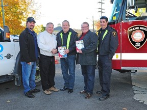 Shown here (L-R) were Steve Davidson, Brent Lemon, Lambton Shores mayor Bill Weber, Grand Bend fire chief Jerry Vanbruaene and fire prevention officer Todd Mellin with the alarms.