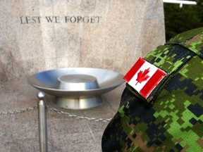 A sergeant from the Princess Patricia's Canadian Light Infantry looks over the memorial at the Military Museum in Calgary, Alta. on Oct. 22, 2014. (Darren Makowichuk/QMI Agency)