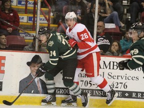 London Knights' Aiden Jamieson, and Tim Getlinger, of Soo Greyhounds, tussle against the boards at Essar Centre in Sault Ste. Marie, Ont., on Sunday, Oct. 12, 2014. (BRIAN KELLY, QMI Agency)