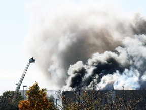 Smoke billows from a building at at Mid-Continent Airport shortly after a twin-turbo airplane crashed into a building, killing several people including the pilot in Wichita, Kan., Oct. 30, 2014. (BRIAN CORN/Reuters/Wichita Eagle/MCT)