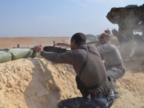 Tribal fighters and Iraqi security forces take part in an intensive security deployment against Islamic State militants on the outskirts of Haditha in this Oct. 26, 2014 file photo. (Reuters/Stringer)