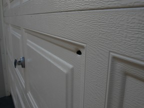 Guns and Gangs detectives are looking into who is responsible for this bullet hole in this garage door on Riga Private.
DOUG HEMPSTEAD/Ottawa Sun