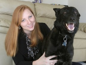 Hollie Anne Fisher, with her dog Tango, has suffered from chronic pain in her upper body since she was in a car accident in 2009. (Michael Lea/The Whig-Standard)