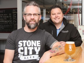 Stone City Ales owners Ron Shore, left, and Eric Dinelle sit at the bar in the tap room at the Princess Street micro brewery, which opened in July. (Julia McKay/The Whig-Standard)