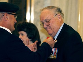 His Honour, Col. (Ret’d) the Honourable Donald S. Ethell gets a poppy pinned on his jacket during the poppy ceremony at the Alberta Legislature in Edmonton, Alberta on Thursday, October 30, 2014. Perry Mah/Edmonton Sun/QMI Agency