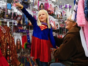 Seven-year-old Alexia Priaulx tries on a costume with help from her mother Bridget Jackson as the rush is on for Halloween costumes on Tuesday, October 28, 2014 at Talize in Peterborough. Clifford Skarstedt/Peterborough Examiner/QMI Agency