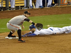 Giants first baseman Brandon Belt (left) catches the ball ahead of Royals first baseman Eric Hosmer (right) for a double play during Game 7 of the World Series in Kansas City on Wednesday. (Christopher Hanewinckel/USA TODAY Sports)