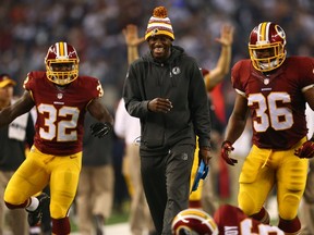 Robert Griffin III, out with an injury, celebrates a TD with his ’Skins ’mates during Monday’s big win in Dallas. (Getty Images)
