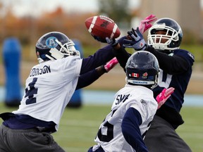 Wide receiver Darryl Surgent (right) battles for the ball during Argos practice yesterday. (Michael Peake/Toronto Sun)