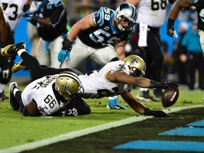 Saints running back Mark Ingram (22) scores a touchdown as Panthers middle linebacker Luke Kuechly (59) defends during second quarter action in Charlotte, N.C., on Thursday, Oct. 30, 2014. (Bob Donnan/USA TODAY Sports)