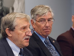 JOHN LAPPA/THE SUDBURY STAR
John Lewko, left, director of the Centre for Research in Human Development at Laurentian University, makes a point as Dr. Andre Hurtubise looks on during a publication launch at the North East LHIN office on Thursday.