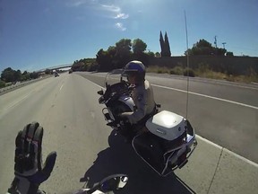 A California motorcycle stuntman intimated a police officer while other bikers performed tricks on a freeway. (gurustunts/YouTube screengrab)