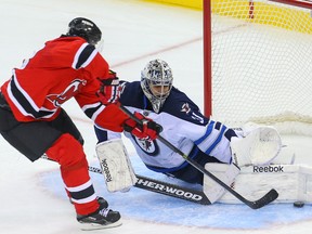 Winnipeg Jets goalie Ondrej Pavelec (31) makes a save on New Jersey Devils right wing Jaromir Jagr (68) during overtime at the Prudential Center. Despite the Devils winning in overtime, there are some positives the Jets can take from the game. (Ed Mulholland-USA TODAY Sports)