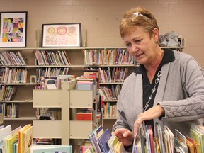 Librarian Karen Gibbs works at the Entwistle School library, which doubles as the community’s public library. Considered the heart of the school and integral to the community, the library staff welcomes local residents looking to browse the shelves during school hours and in the evening. - Karen Haynes, Reporter/Examiner