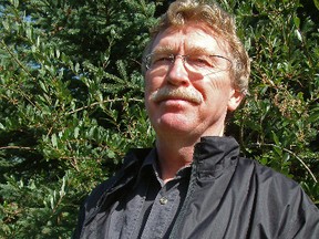 Author Fred Stenson hold his previous novel The Great Karoo in this file photo. He will be doing a reading from his newest book, Who By Fire, at the Kootenai Brown Pioneer Village on Nov. 4, 2014.