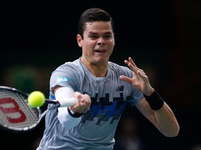 Milos Raonic of Canada returns a shot against Switzerland's Roger Federer during their quarterfinal match at the Paris Masters tennis tournament at the Bercy sports hall on October 31, 2014. (REUTERS/Benoit Tessier)