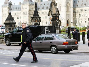 Police guard a car of the suspect in a shooting of a Canadian soldier at the Canadian War Memorial in Ottawa in this Oct. 22, 2014 file photo. (CHRIS WATTIE/Reuters)