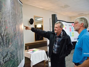 A resident points out his house on a map to an AltaLink employee during the first round of public consultations for a new transmission project at the Heritage Inn last Saturday. AltaLink also held a session in Lundbreck last Wednesday. John Stoesser photo/QMI Agency