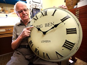 Hess Nyenhuis from Golden Hour Clock Shop turns back the clock for daylight saving time in Edmonton, Alberta on September 3, 2014. (File photo)