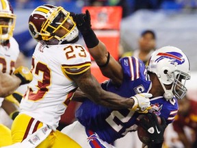 Washington Redskins defender DeAngelo Hall tries to tackle Buffalo Bills running back Fred Jackson during NFL play. (REUTERS/Mark Blinch)