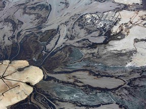 Oil goes into a tailings pond at the Suncor oilsands operations near Fort McMurray, Alberta, September 17, 2014. In 1967 Suncor helped pioneer the commercial development of Canada's oilsands, one of the largest petroleum resource basins in the world. Picture taken September 17, 2014.  REUTERS/Todd Korol