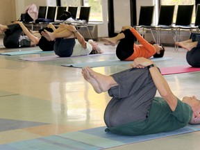 Seniors take part in a yoga class at an active lifestyle centre.
(Postmedia Network)