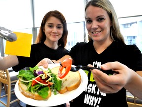 Katey Davidson (right) and Natalia Trovato, Brescia University College students and members of the Fresh Club, prepare a sandwich during an interactive cooking class for new international students at Western University Oct. 24, 2014. CHRIS MONTANINI\LONDONER\QMI AGENCY