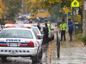 A woman faces criminal charges for allegedly running down a Toronto Police Parking Enforcement officer on a residential street near St. Clair Ave. E. and Mount Pleasant Rd. Friday morning. The officer suffered minor injuries. (CHRIS DOUCETTE/Toronto Sun)