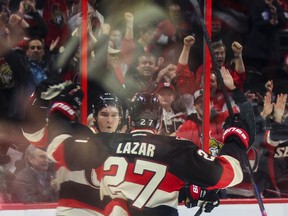 Mark Stone is congratulated by linemate Curtis Lazar on his goal Thursday night against the Blackhawks. (ERROL McGIHON/OTTAWA SUN)