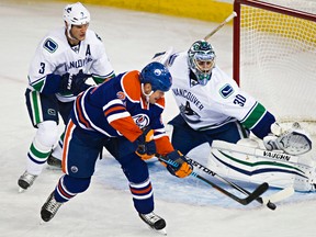 Matt Hendricks tries to put the puck past Canucks goalie Ryan Miller the last time the two teams met on Oct. 17, with the OIlers coming out on the losing end of a 2-0 score. (Codie McLachlan, Edmonton Sun)