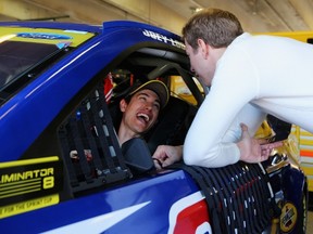 Teammates Brad Keselowski (right) and Joey Logano share a laugh  in the garage area during practice for the NASCAR Sprint Cup Series AAA Texas 500 at Texas Motor Speedway yesterday. (AFP)