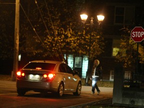 One of three undercover female officers used during the sweep approaches a vehicle stopped along Montreal Rd. Drivers who stop face a charge of impeding traffic for the purpose of prostitution -- many of them are placed in the so-called john school pre-charge diversion program.DOUG HEMPSTEAD/Ottawa Sun