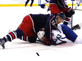 Blue Jackets forward Adam Cracknell pins Maple Leafs’ Nazem Kadri to the ice in Columbus last night. (USA TODAY)