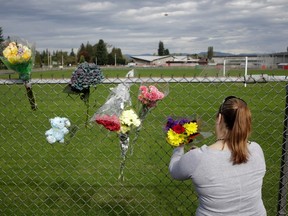 Visitors leave flowers the day after a shooting at Marysville-Pilchuck High School in Marysville, Washington October 25, 2014. A student fatally shot one classmate and wounded four others when he opened fire in the cafeteria of his Washington state high school on Friday, following a fight with fellow students, authorities said. The shooter took his own life as Marysville-Pilchuck High School students scrambled to safety in the latest outburst of deadly violence at an American school. REUTERS/Jason Redmond