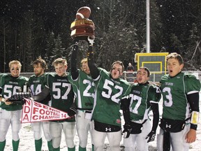 Dave Dale/The Nugget 
The West Ferris Trojans senior football team captains raise NDA championship trophies after beating the Algonquin Barons 7-0 at Steve Omischl Sports Field Complex, Friday. From left, Jacob Brown, Conner Andrews, Lucas Trach, Jessie Pledge, Zach Mason, Nick Orton and quarterback Matt Valiquette.