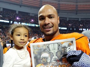 Paris Jackson holds his daughter as he celebrates after the B.C. Lions defeated the Winnipeg Blue Bombers in the CFL’s 99th Grey Cup in Vancouver on Nov. 27, 2011. Sun file/Reuters