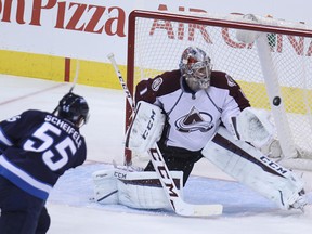 Winnipeg Jets centre Mark Scheifele fires a shot off the post behind Colorado Avalanche goaltender Semyon Varlamov during NHL action at MTS Centre in Winnipeg, Man., on Sun., Oct. 26, 2014.