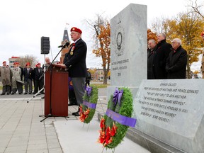 John Keay, acting president of the Hastings and Prince Edward Regiment Association, speaks during a ceremony unveiling a monument to the regiment outside the Quinte courthouse in Belleville Saturday. Behind the monument from left are Prince Edward-Hastings MPP Todd Smith, MPP Daryl Kramp, Northumberland-Quinte West MPP Lou Rinaldi, and Justice Robert Scott, the regiment's honorary lieutenant-colonel.