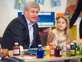 Prime Minister Stephen Harper sits next to a student while doing arts and crafts at the Joseph & Wolf Lebovic Jewish Community Campus school in Vaughan October 30, 2014. (REUTERS/Mark Blinch)