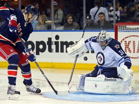 One of Ondrej Pavelec's 38 big saves against the Rangers on Saturday. (ADAM HUNGER/USA Today)