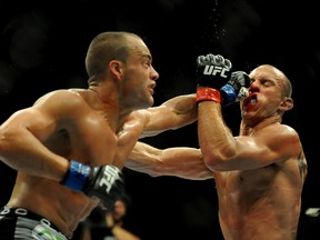 Eddie Alvarez (blue gloves) lands a punch on Donald Cerrone (red gloves) during UFC 178 in Las Vegas on Sept. 27, 2014. (Stephen R. Sylvanie/USA TODAY Sports)