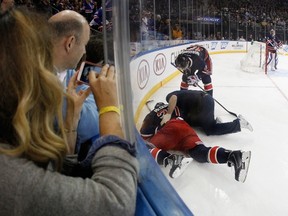 Ryan McDonagh #27 of the New York Rangers is injured when he is hit into the boards by Evander Kane #9 of the Winnipeg Jets during the first period at Madison Square Garden on November 1, 2014 in New York City. (Bruce Bennett/Getty Images/AFP)